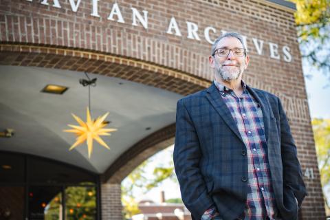 Scott Gordon stands in front of the Moravian Archives building.